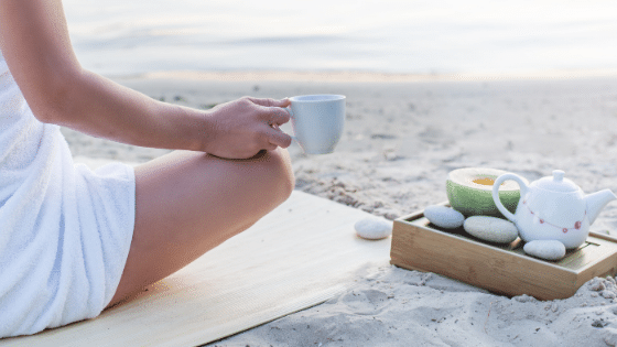 caregiver-tips-woman-sitting-on-beach-with-tea